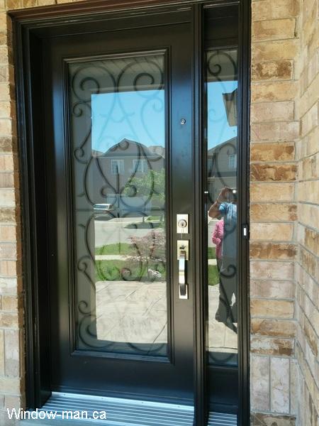 Single insulated steel entry front door with one sidelite. Black. Bristol iron glass inserts. Peephole
